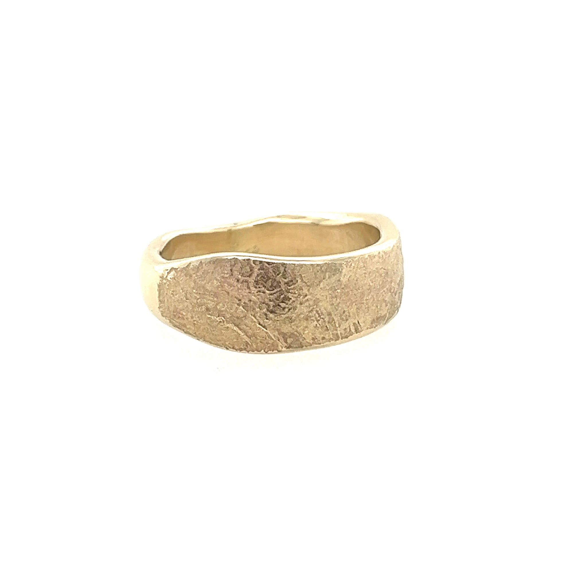 Gold ring with a textured surface on a white background