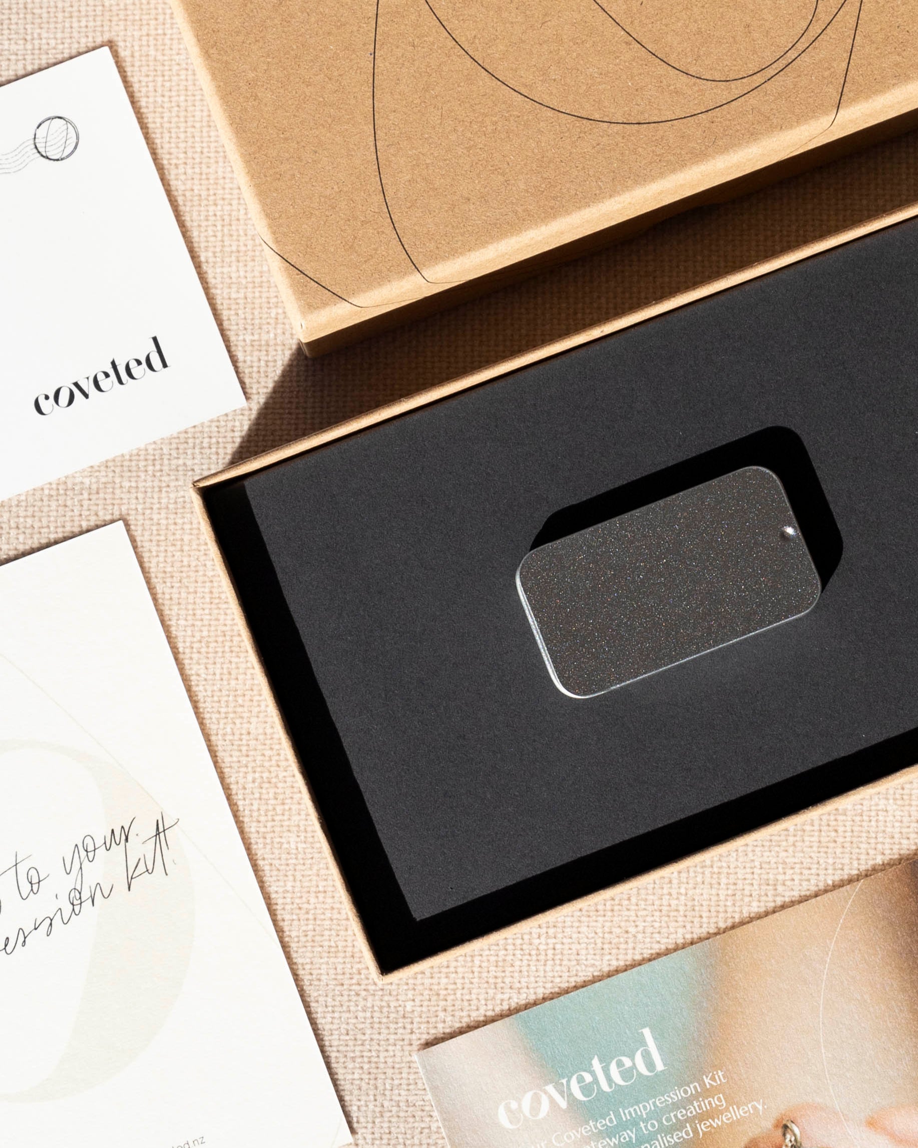 Product packaging with 'coveted' branding on a neutral background