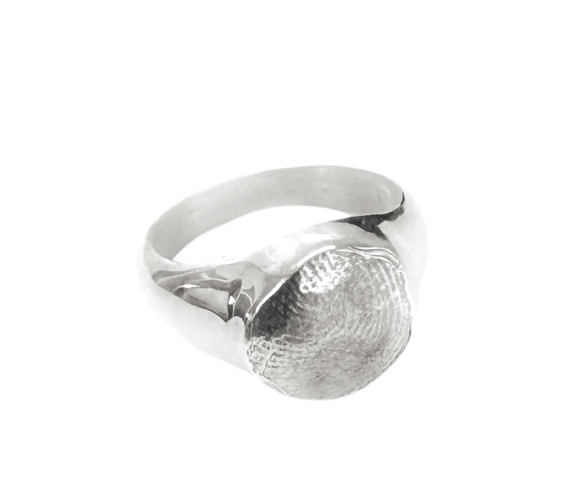 Silver ring with a textured surface on a white background